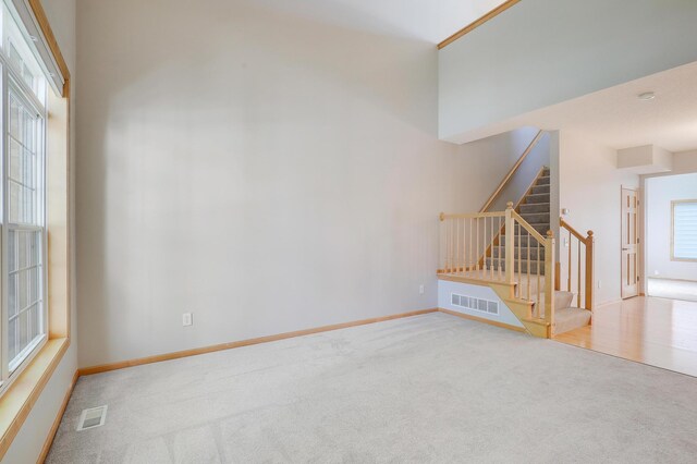 9633 Belmont Ln, Eden Prairie, MN 55347 - unfurnished living room with carpet floors and stairway
