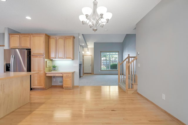 9633 Belmont Ln, Eden Prairie, MN 55347 - kitchen with stainless steel refrigerator with ice dispenser, light wood-style floors, light countertops, a chandelier, and pendant lighting
