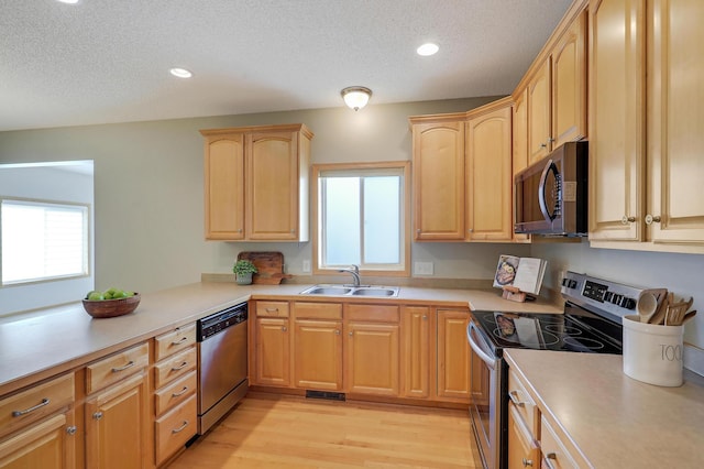 9633 Belmont Ln, Eden Prairie, MN 55347 - kitchen featuring stainless steel appliances, a textured ceiling, light countertops, light brown cabinets, and recessed lighting