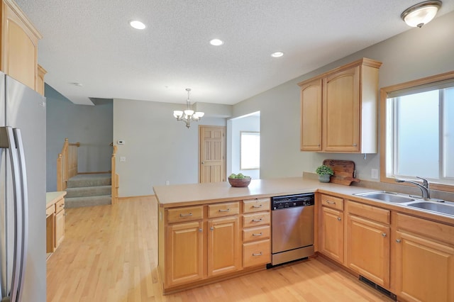 9633 Belmont Ln, Eden Prairie, MN 55347 - kitchen with freestanding refrigerator, stainless steel dishwasher, a peninsula, a textured ceiling, and healthy amount of natural light