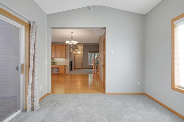 9633 Belmont Ln, Eden Prairie, MN 55347 - hall featuring light colored carpet, a chandelier, and vaulted ceiling