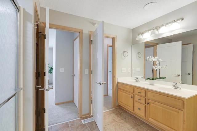 9633 Belmont Ln, Eden Prairie, MN 55347 - bathroom with double vanity and a textured ceiling