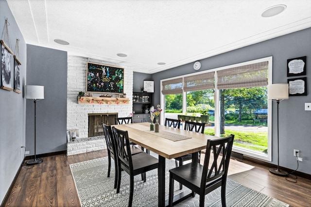 315 Ugstad Rd, Proctor, MN 55810 - dining room with wood finished floors and a brick fireplace