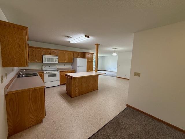 625 Meeker Ct NW, Evansville, MN 56326 - kitchen with white appliances, a center island, brown cabinets, and light countertops