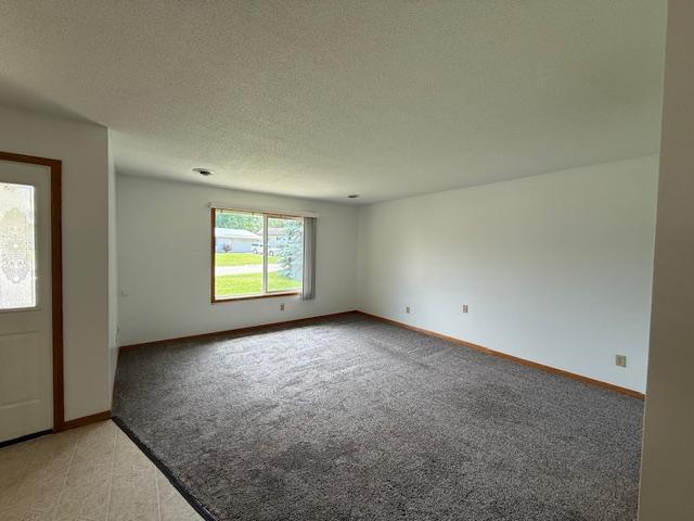 625 Meeker Ct NW, Evansville, MN 56326 - entryway featuring light colored carpet and a textured ceiling