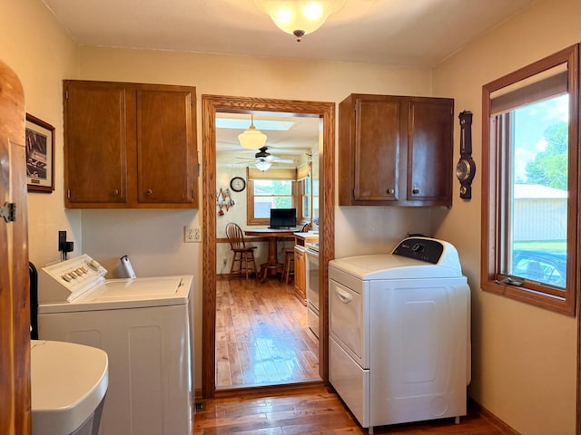 15467 Twilight Rd, Onamia, MN 56359 - washroom featuring washing machine and clothes dryer, wood-type flooring, cabinet space, an office area, and ceiling fan