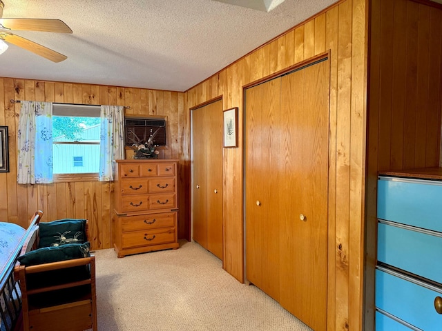15467 Twilight Rd, Onamia, MN 56359 - living area featuring wooden walls, light colored carpet, a textured ceiling, and ceiling fan