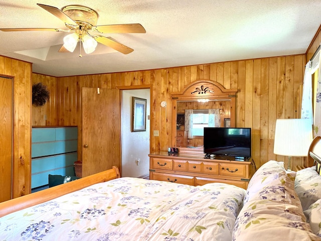 15467 Twilight Rd, Onamia, MN 56359 - bedroom with wooden walls, a textured ceiling, and a ceiling fan