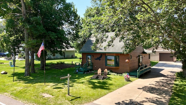 15467 Twilight Rd, Onamia, MN 56359 - view of front of house with an outdoor structure, roof with shingles, a front lawn, and a garage
