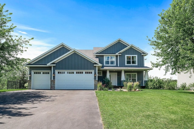 7804 Stafford Trl, Savage, MN 55378 - craftsman-style house with board and batten siding, asphalt driveway, a front yard, a garage, and covered porch