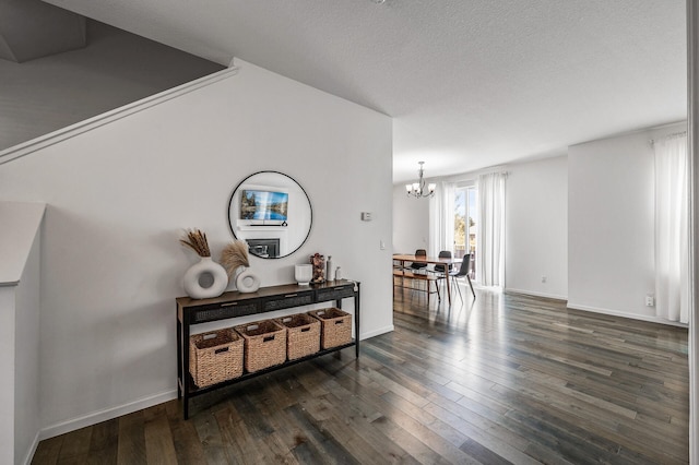 7804 Stafford Trl, Savage, MN 55378 - hall with a chandelier, dark wood-style flooring, and a textured ceiling