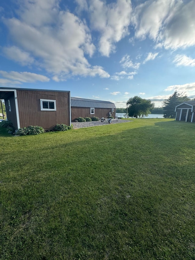 34463 Green Valley Rd SE, Woodside Twp, MN 56736 - view of green lawn with a water view and a shed