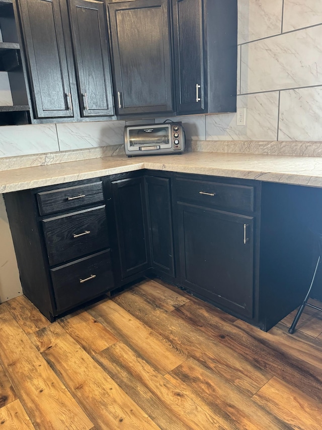 34463 Green Valley Rd SE, Woodside Twp, MN 56736 - kitchen with dark wood-style flooring, light countertops, blue cabinetry, and open shelves