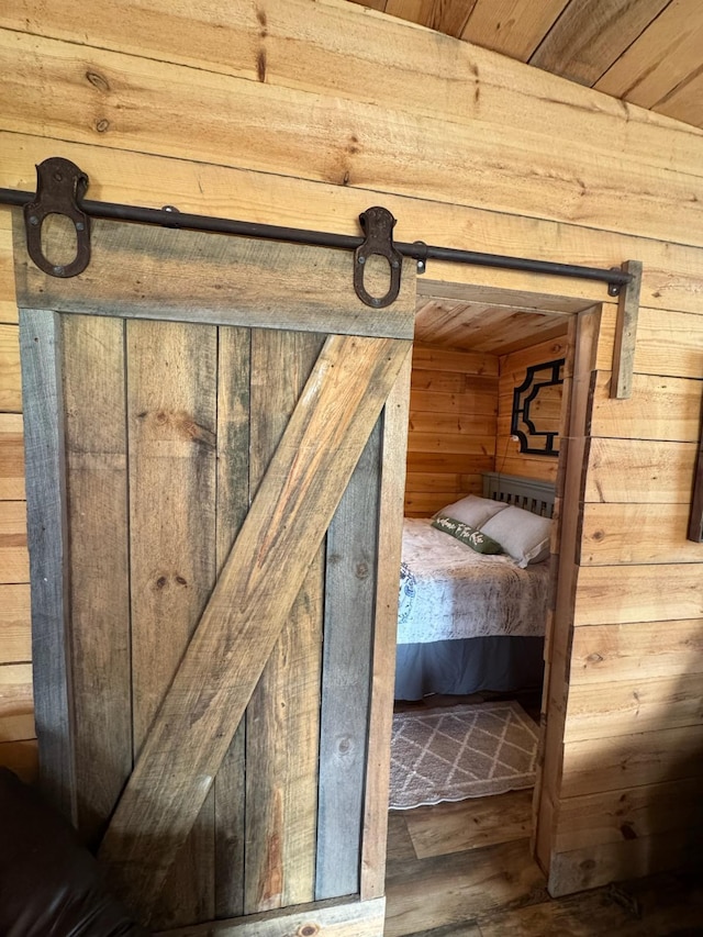 34463 Green Valley Rd SE, Woodside Twp, MN 56736 - unfurnished bedroom featuring wood walls and wood finished floors