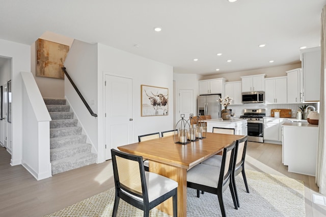 18695 Kennedy St NW, Elk River, MN 55330 - dining room with light wood-style floors, recessed lighting, and stairs