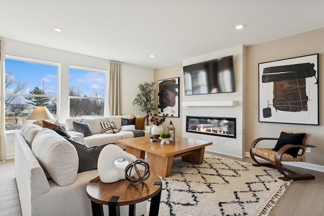 18695 Kennedy St NW, Elk River, MN 55330 - living area featuring a glass covered fireplace, light wood-type flooring, and recessed lighting