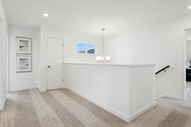 18695 Kennedy St NW, Elk River, MN 55330 - hall featuring a chandelier, carpet floors, an upstairs landing, and recessed lighting