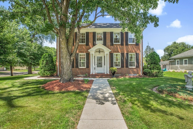 426 Armstrong Ave, Litchfield, MN 55355 - colonial home featuring brick siding and a front lawn