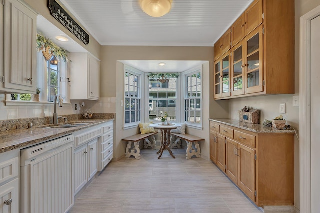 426 Armstrong Ave, Litchfield, MN 55355 - kitchen featuring white dishwasher, plenty of natural light, and light stone counters
