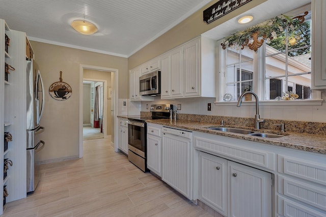 426 Armstrong Ave, Litchfield, MN 55355 - kitchen featuring appliances with stainless steel finishes, white cabinets, stone counters, crown molding, and light wood-type flooring