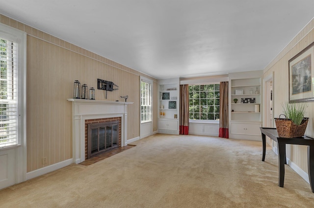 426 Armstrong Ave, Litchfield, MN 55355 - unfurnished living room with carpet, a fireplace, wood walls, and built in shelves