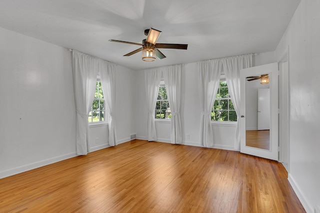 426 Armstrong Ave, Litchfield, MN 55355 - empty room with ceiling fan and wood finished floors