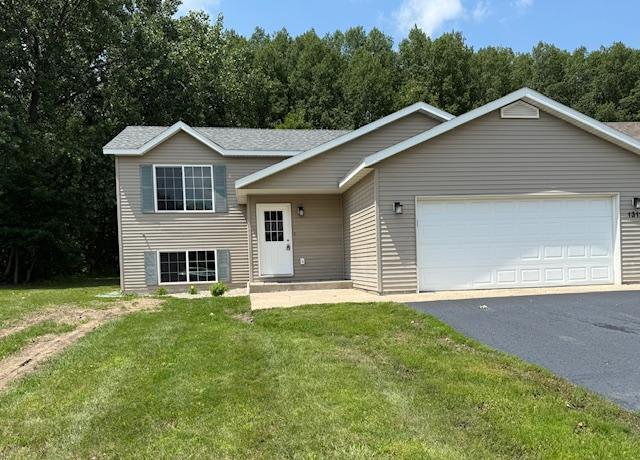 1312 Natures Trl, Alexandria, MN 56308 - tri-level home with driveway, a front yard, and an attached garage