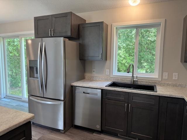 1312 Natures Trl, Alexandria, MN 56308 - kitchen featuring appliances with stainless steel finishes, light countertops, and light wood-style flooring