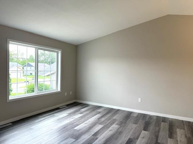 1312 Natures Trl, Alexandria, MN 56308 - spare room featuring wood finished floors and vaulted ceiling
