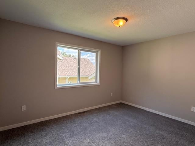 1312 Natures Trl, Alexandria, MN 56308 - empty room with dark carpet and baseboards
