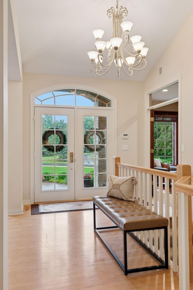 100 River Bluff Pl NW, Rochester, MN 55901 - doorway with lofted ceiling, a chandelier, wood finished floors, and french doors
