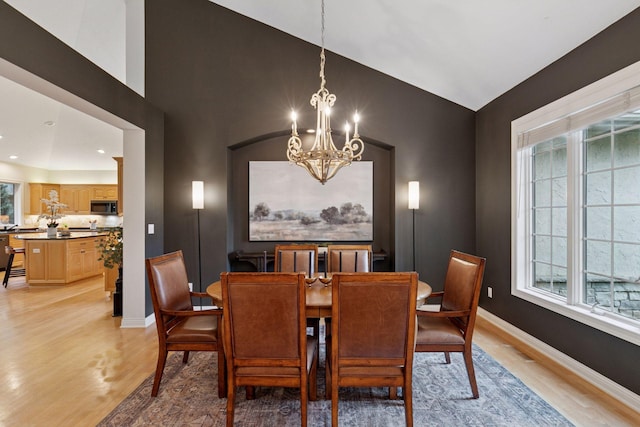 100 River Bluff Pl NW, Rochester, MN 55901 - dining area featuring a chandelier, light wood-type flooring, and vaulted ceiling