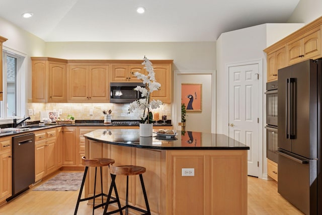 100 River Bluff Pl NW, Rochester, MN 55901 - kitchen with appliances with stainless steel finishes, a center island, light wood finished floors, decorative backsplash, and recessed lighting