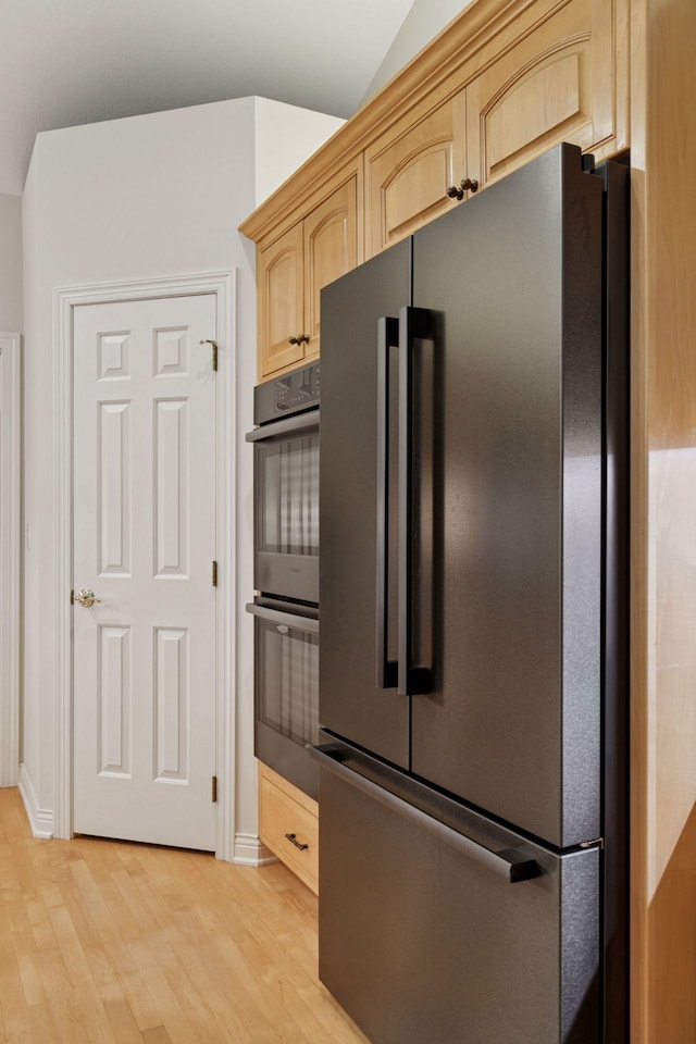 100 River Bluff Pl NW, Rochester, MN 55901 - kitchen featuring freestanding refrigerator, stainless steel double oven, light brown cabinetry, and light wood-type flooring