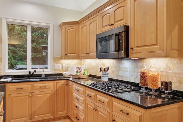 100 River Bluff Pl NW, Rochester, MN 55901 - kitchen with appliances with stainless steel finishes, dark stone counters, and decorative backsplash