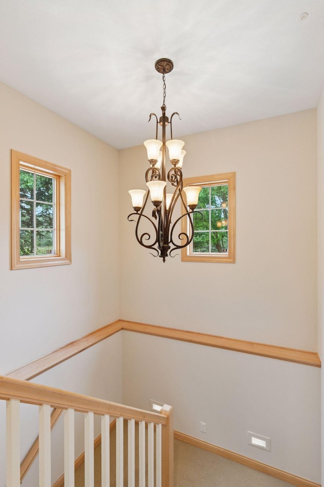 100 River Bluff Pl NW, Rochester, MN 55901 - staircase featuring carpet and a chandelier