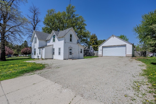 812 Main St, Dodge Center, MN 55927 - view of home's exterior featuring an outbuilding, a detached garage, and a yard
