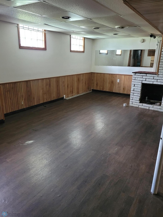 1140 19th St N, Fargo, ND 58102 - below grade area with wainscoting, a brick fireplace, and dark wood-style flooring