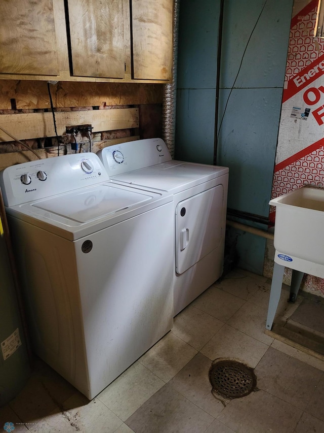 1140 19th St N, Fargo, ND 58102 - laundry area with washer and dryer, cabinet space, and water heater