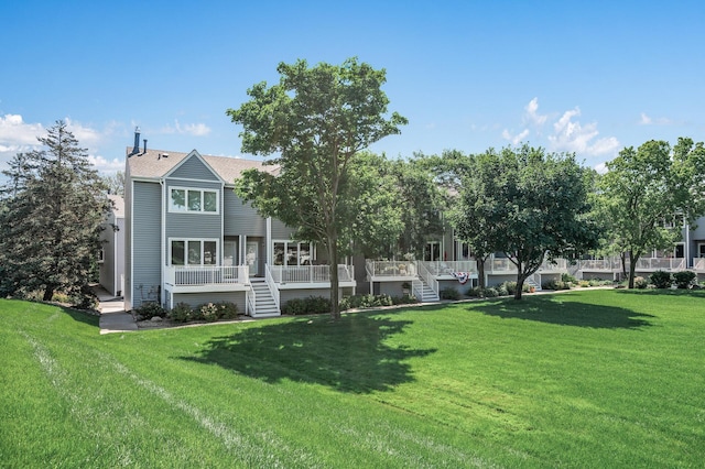 1575 Wayzata Blvd Unit A, Long Lake, MN 55356 - back of house featuring stairs and a lawn