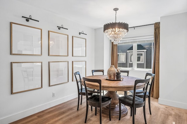 1575 Wayzata Blvd Unit A, Long Lake, MN 55356 - dining space with a chandelier and light wood-style flooring