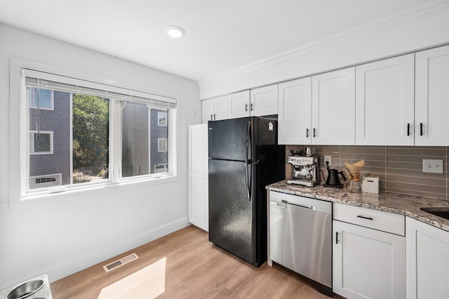 1575 Wayzata Blvd Unit A, Long Lake, MN 55356 - kitchen featuring dishwasher, freestanding refrigerator, decorative backsplash, white cabinetry, and light stone counters