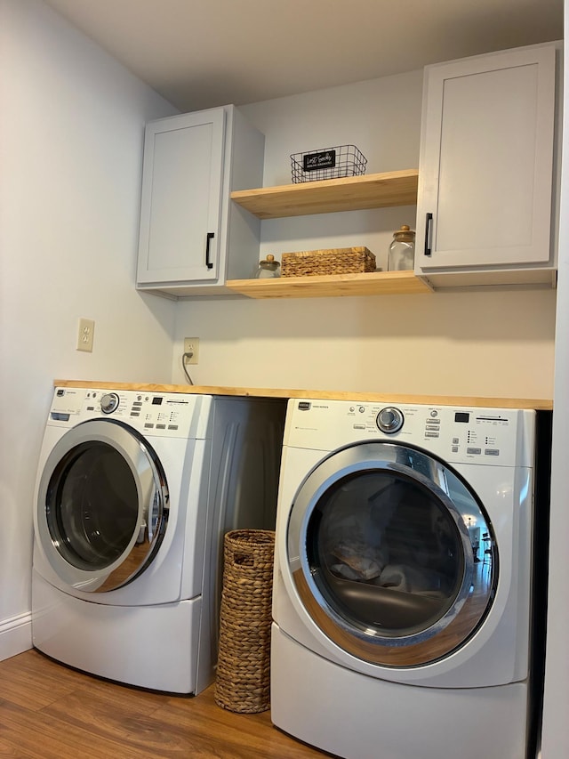 410 Atlantic Ave W, Grove City, MN 56243 - laundry area featuring washer and clothes dryer, wood finished floors, and cabinet space