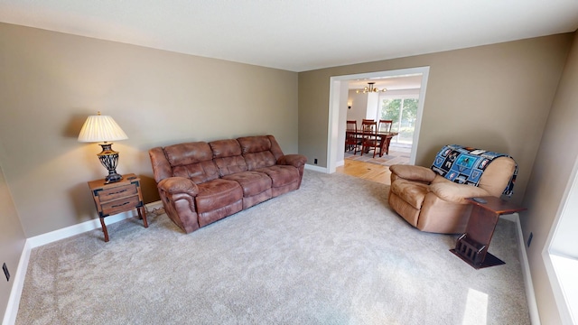 410 Atlantic Ave W, Grove City, MN 56243 - living room featuring carpet flooring and a chandelier