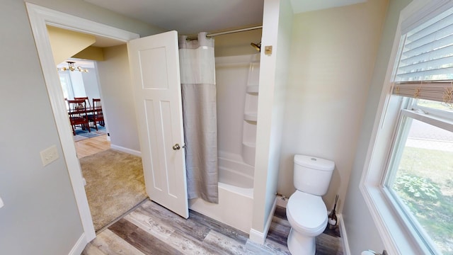 410 Atlantic Ave W, Grove City, MN 56243 - full bathroom with a chandelier, wood finished floors, shower / tub combo with curtain, and healthy amount of natural light