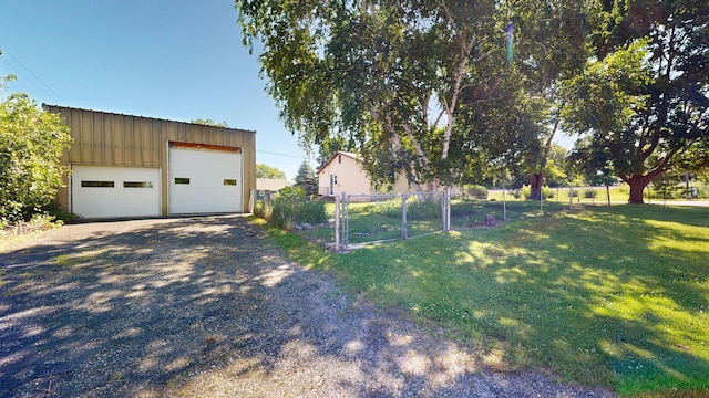 410 Atlantic Ave W, Grove City, MN 56243 - view of yard featuring a detached garage, an outdoor structure, and a gate