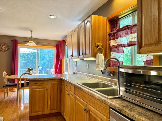 18611 327th Ave, Isle, MN 56342 - kitchen with a textured ceiling, hardwood / wood-style floors, a peninsula, pendant lighting, and dishwasher