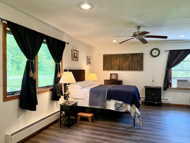 18611 327th Ave, Isle, MN 56342 - bedroom with a baseboard radiator, baseboard heating, wood finished floors, cooling unit, and recessed lighting