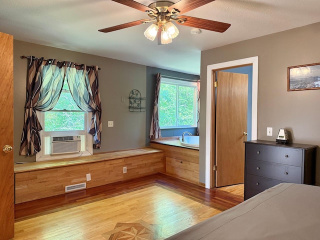 18611 327th Ave, Isle, MN 56342 - unfurnished bedroom featuring wood finished floors, cooling unit, and a ceiling fan