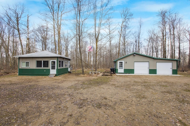 5134 Briar Ln SW, Meadowbrook Twp, MN 56466 - view of property exterior with a detached garage, an outbuilding, and view of wooded area